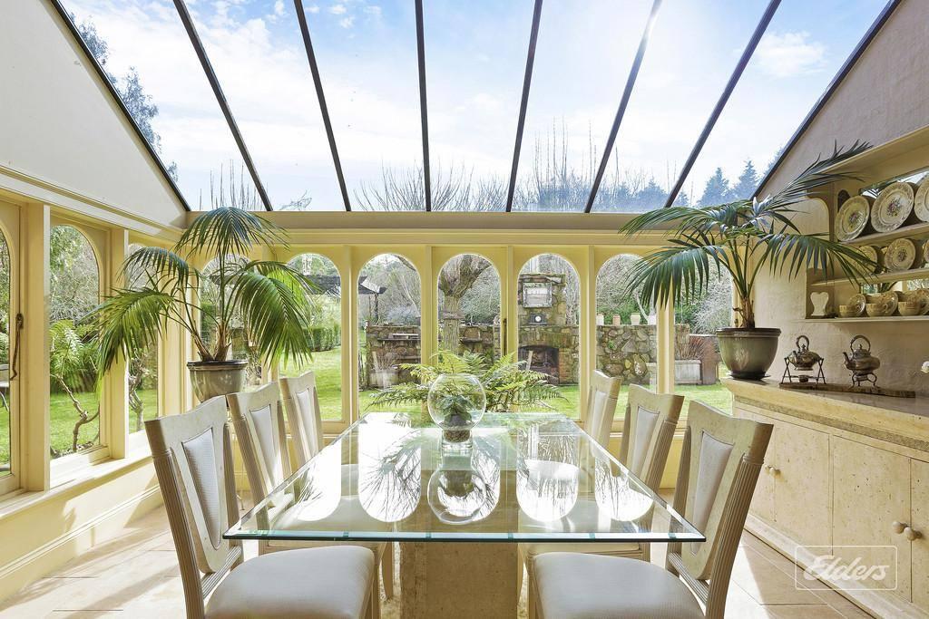 The back of the house on this rural property for sale Tasmania features a large glassed-roof atrium area